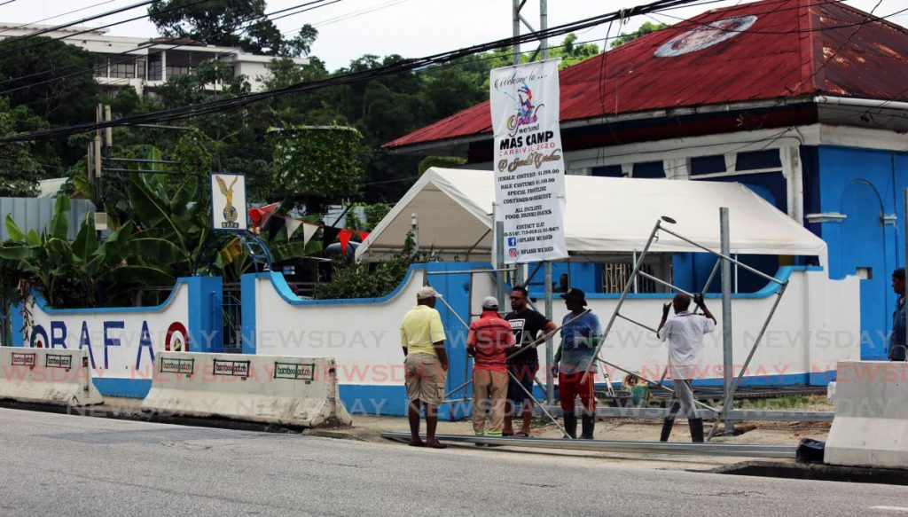 A crew places a fence around the car park of the Royal Air Force Association (RAFA) Circular Road, Queen's Park East, Port of Spain.  - SUREASH CHOLAI