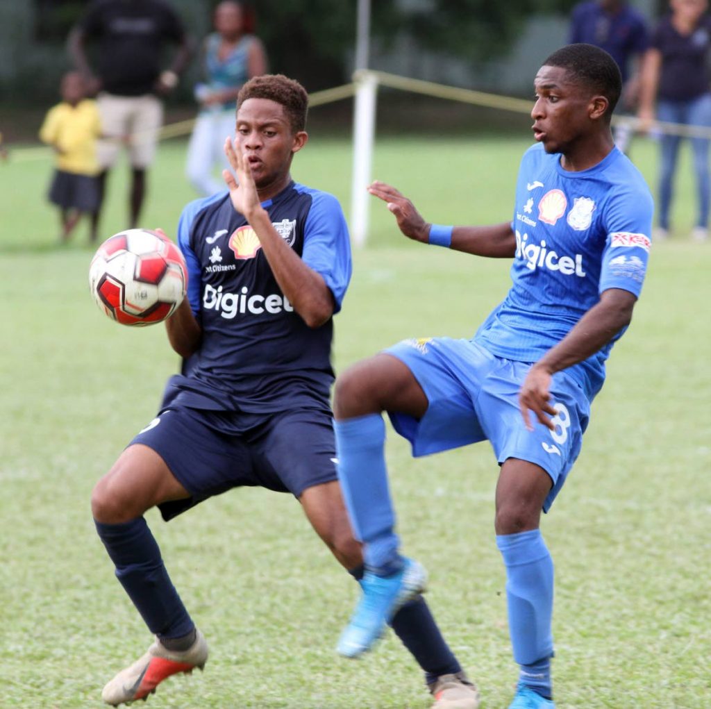 Naparima College’s Kodel Frontin (R) and Nathaniel Brown, of Queen’s Royal College, battle for the ball during the Secondary Schools Football League premier division match,held at St Mary’s College Grounds,yesterday. - ANGELO_MARCELLE