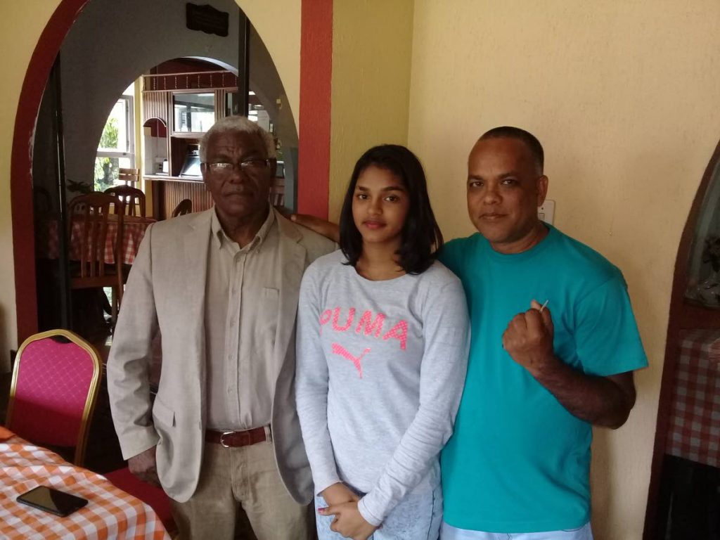 Boxing promoter Buxo Potts, from left, Faith Ramnath and her father Russell. - Jelani Beckles