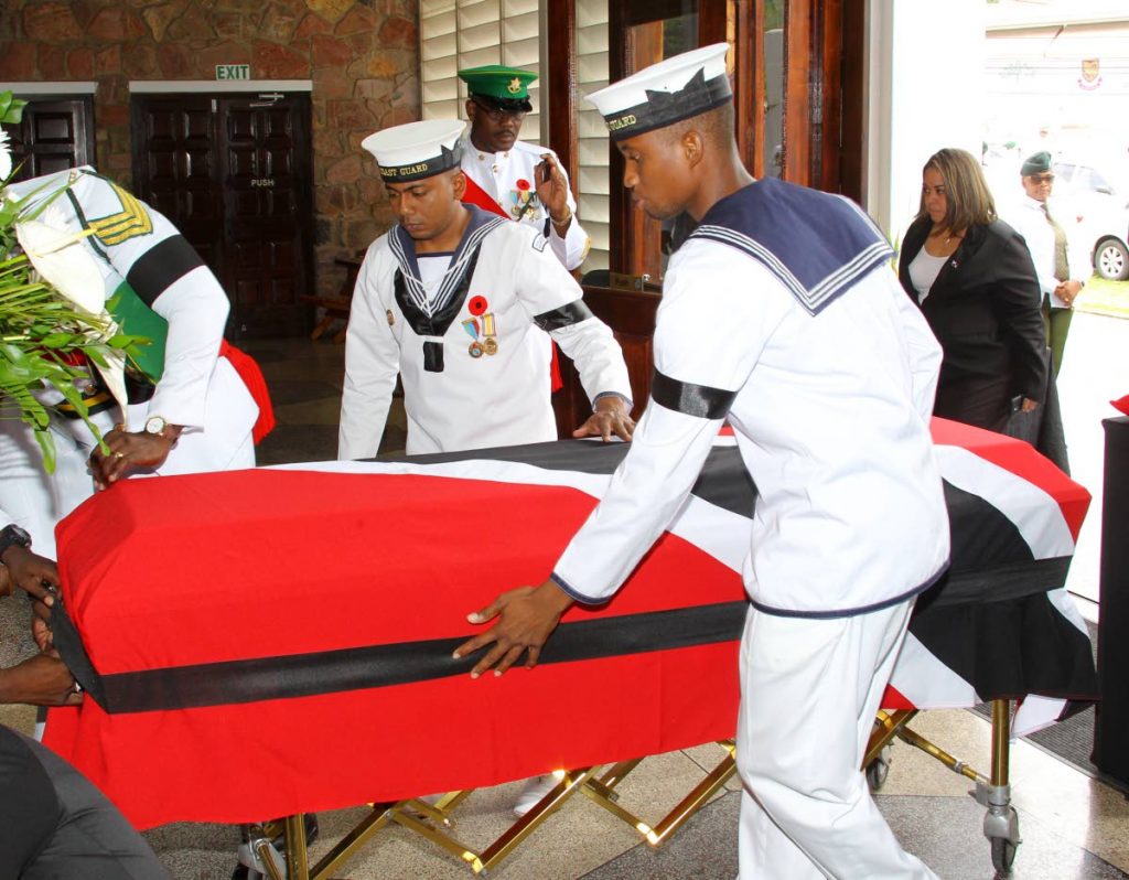 LAST TRIP: The flag-draped coffin is brought into the Church of the Assumption in Maraval for the funeral of former chief justice Clinton Bernard. PHOTO BY ROGER JACOB 