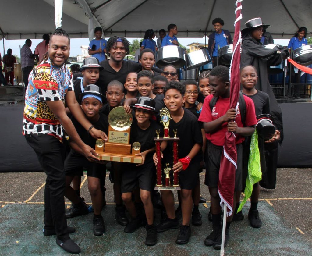 Self-styled Governor of Culture Brandon Valley presents San Fernando Boys RC students with the trophy as winners in the primary school category of NGC Pan Fest Pan Jamboree, Pleasantville Community Centre, on Friday. PHOTO BY VASHTI SINGH - Vashti Singh