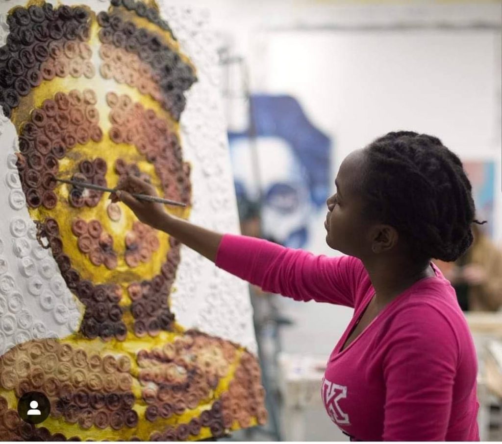 Nneka Jones paints a portrait of a girl on a canvas of condoms for her Target project. PHOTO COURTESY NNEKA JONES - 