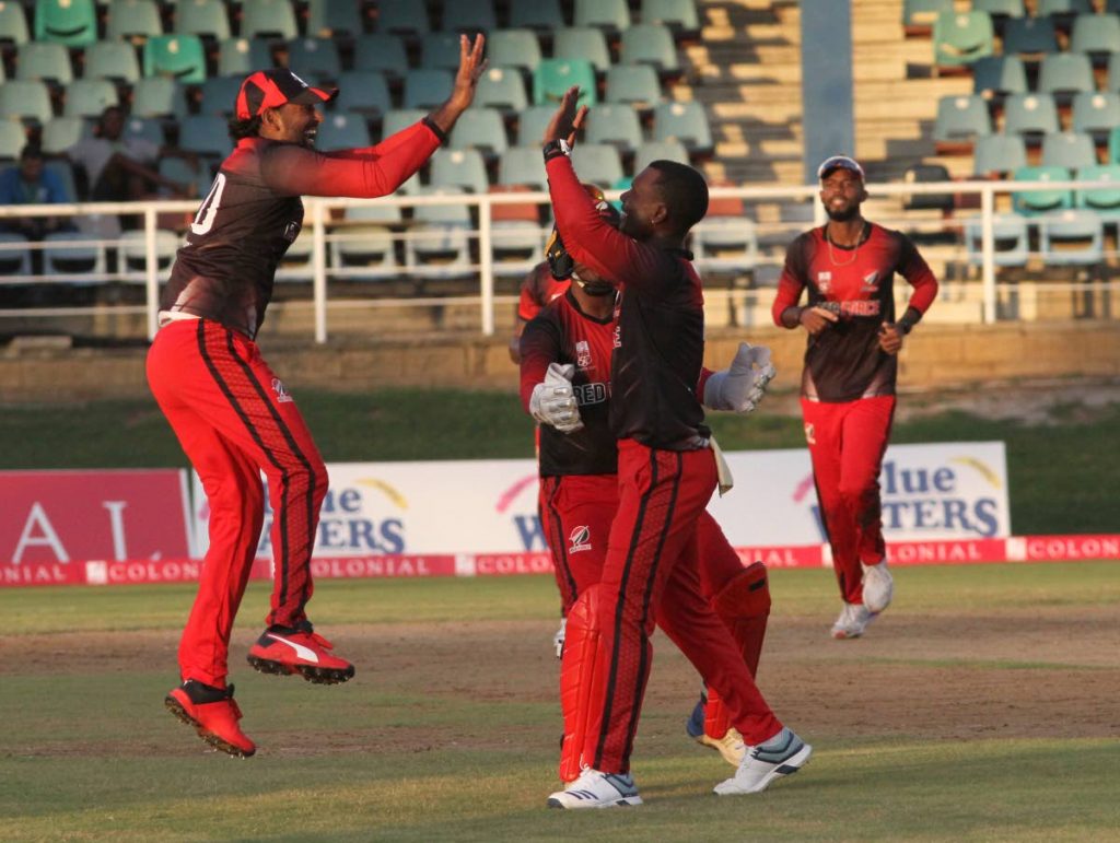 In this file photo, TT Red Force Imran Khan, Steven Katwaroo and Jason Mohammed celebrate after taking a wicket against Guyana Jaguas during the Colonial Medical Insurance Super 50 match, at the Queen’s Park Oval, on Nov 9. - Ayanna Kinsale