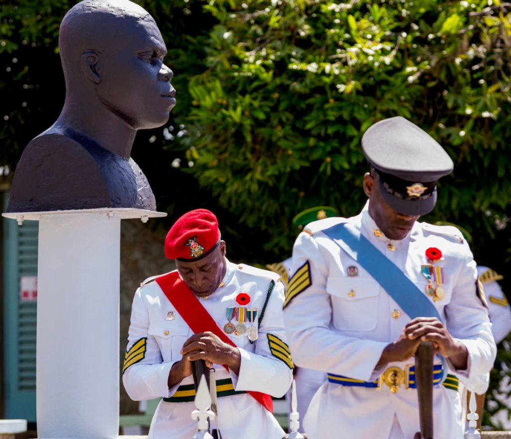 WE REMEMBER: Members of the Defence Force observe two-minutes of silence yesterday, Memorial Day, at James Park in Scarborough.  - DAVID REID 