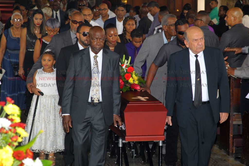 Friends of the late sports journalist Dave Lamy former Fifa vice president Jack Warner (L) and Joe Hadeed (R) carry his casket at the end of Lamy's funeral, at the Holy Trinity Cathedral, Port of Spain. - ROGER JACOB