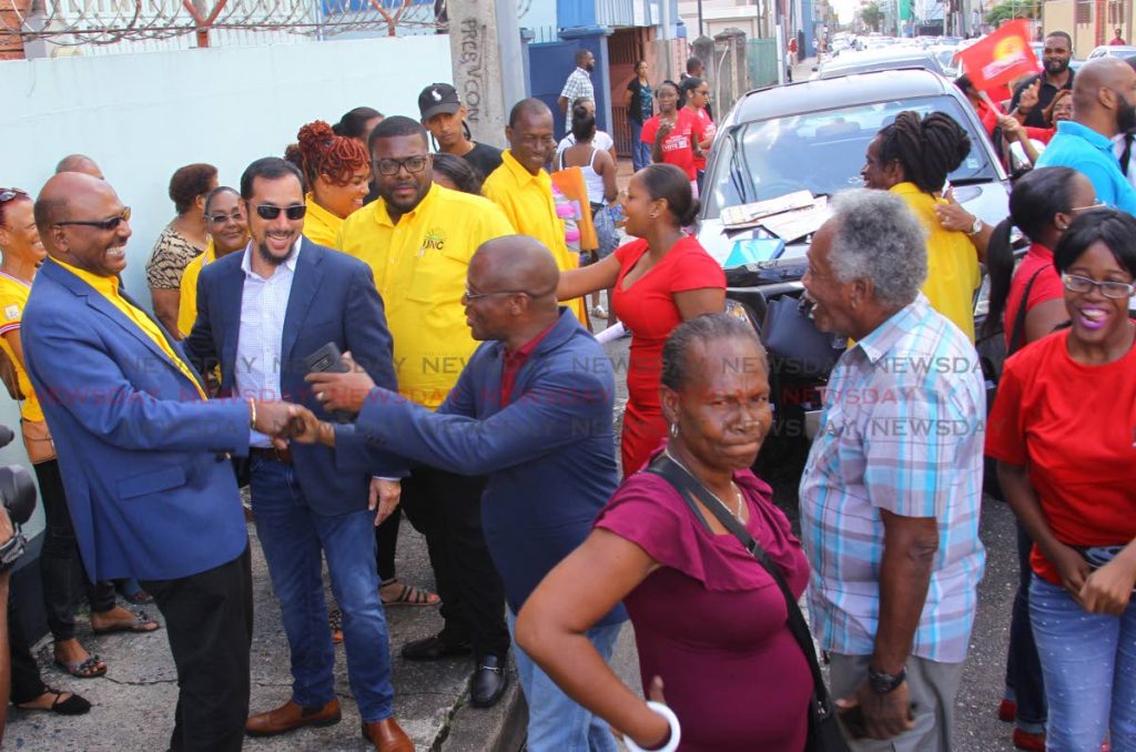 Opposition Senator Wade Mark , MP for Port of Spain North/St Anns West Stuart Young and Alderman Wendell Stephens greet each other as a crowd of PNM and UNC supporters converged at the Office of the Returning Officer District Office located at 123 Henry Street, Port of Spain. - ROGER JACOB