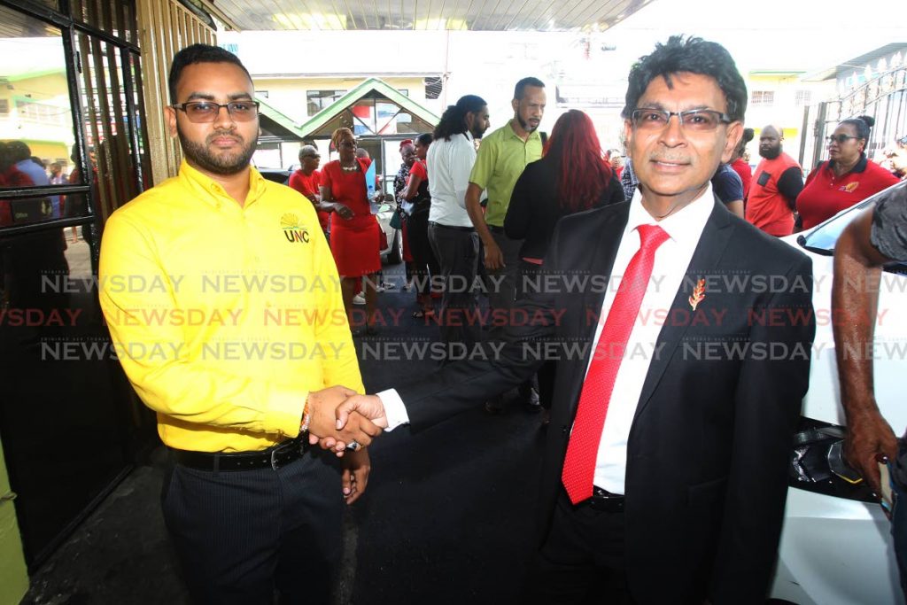 UNC candidate for Les Effort east, Sachin Maharaj, and Ryaad Hosein, the PNM candidate for the same district, greet each other before filing nomination papers on Rushworth Street, San Fernando, on Monday. - Lincoln Holder