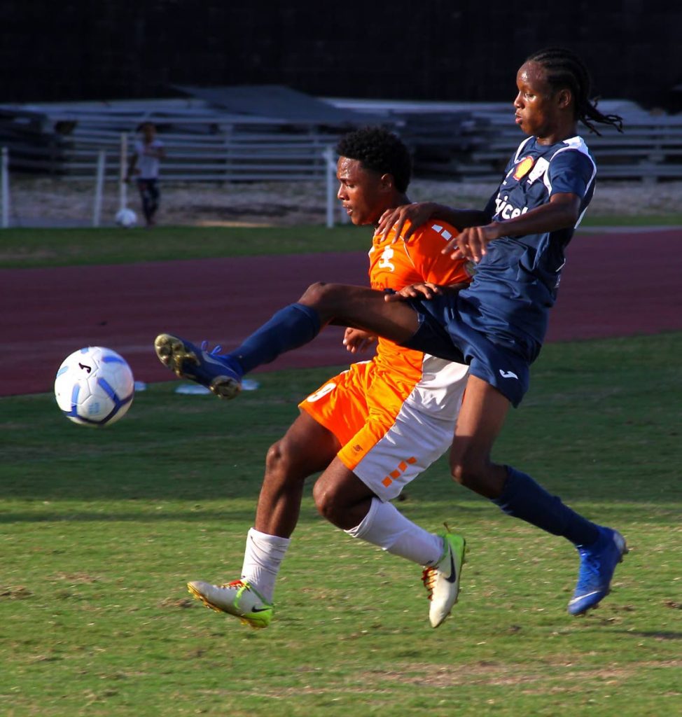 Remy Butler (L), of Valencia Secondary, and Antonio CheeTing of TrinityEast battle for the ball during yesterday’s match in the Coca Cola Intercol East Zonal semi-final. - Roger Jacob