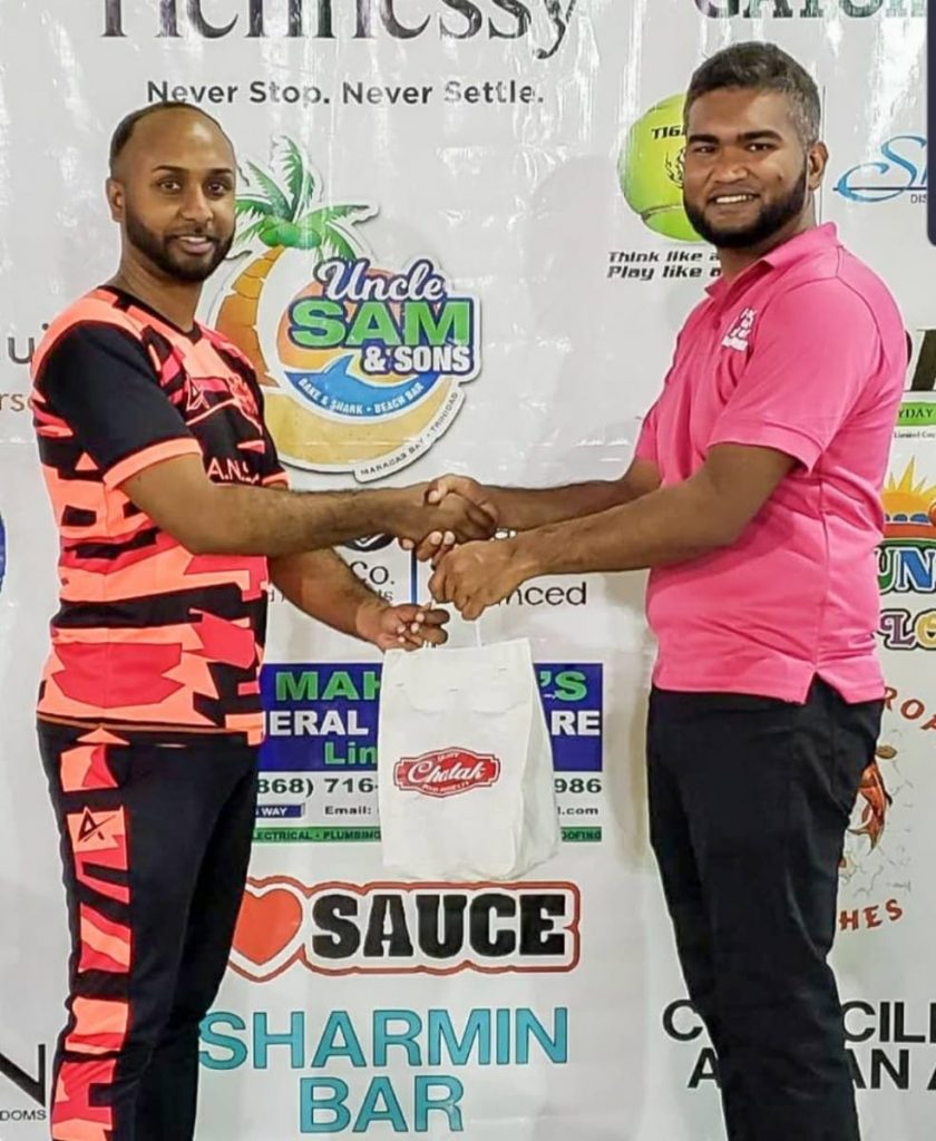 Same Side's Christopher Jagmohan, left, receives his Man of the Match award from an official following a quickfire knock of 56 at the Hennessy Central Super 6's Windball Tournament, on Monday. - 