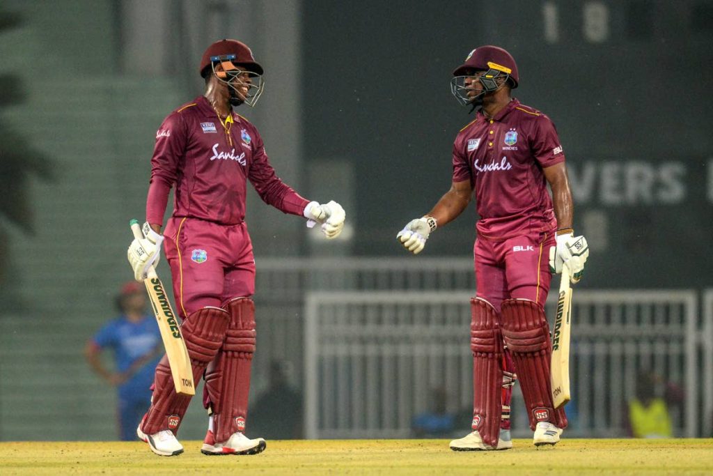 Evin Lewis, right, celebrates with team-mate Shimron Hetmyer after getting his half century during the first T20 international match at Ekana Cricket Stadium in Lucknow, today. Photo by Rohit Umrao/AFP  - ROHIT UMRAO