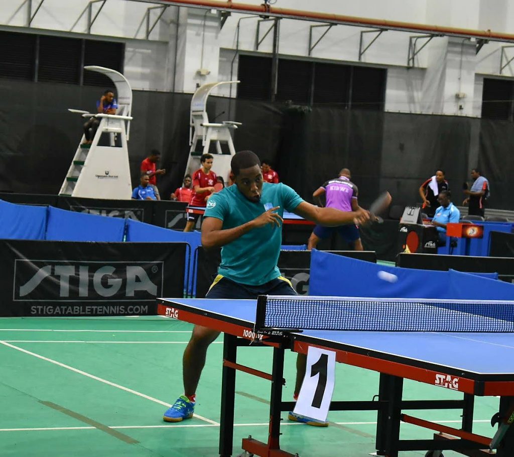 Shemar Britton plays a backhand shot during the opening day of the WASA Table Tennis Tournament on Thursday. PHOTO BY SHERDON PIERRE. - Sherdon Pierre