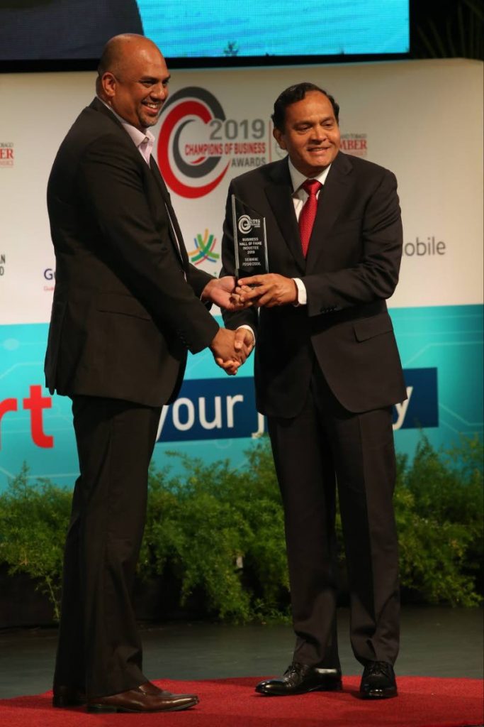 Guardian Life president Anand Pascal presents the Business Hall of Fame award to Coosal’s Group of Companies chairman Sieunarine Coosal at the TT Chamber of Industry and Commerce's Champions of Business Awards ceremony at NAPA, Port of Spain on Friday night. - Angelo Marcelle