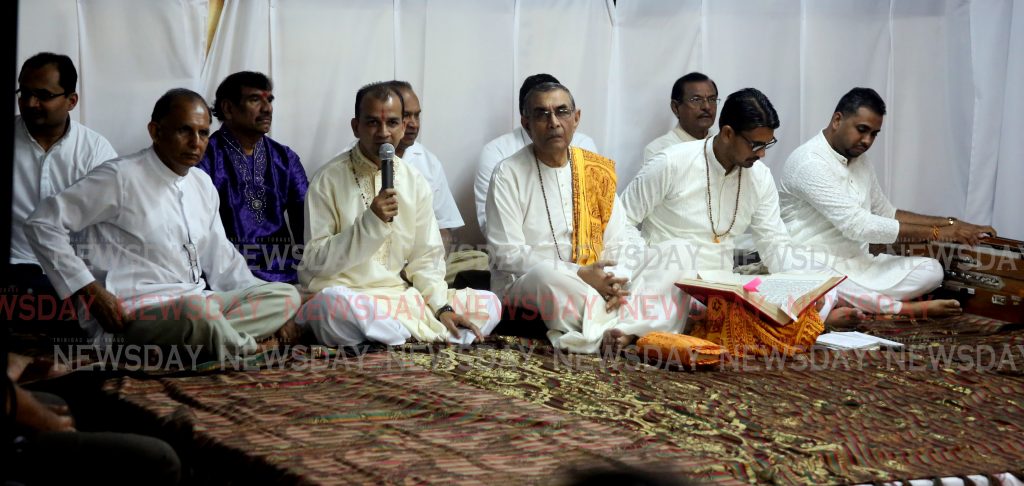 The Dharmacharya of the Sanatan Dharma Maha Sabha Pundit Dr Rampersad Parasram middle leads pundits in prays during the wake on Sunday evening at the Champs Fleurs home of the late secretary general of the Maha Sabha 

PHOTO SUREASH CHOLAI