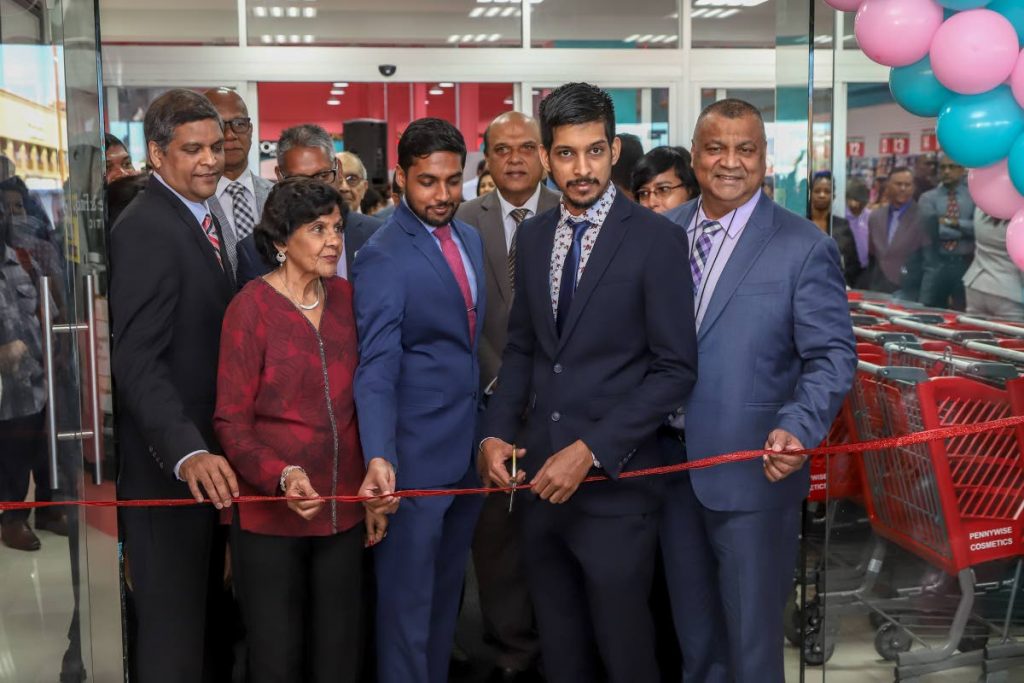 IN BUSINESS: CEO & managing director Dalvi Paladee, owner Shanti Paladee, director Shivum Paladee, director Satyam Paladee and Roopnarine Oumade Singh - executive director RBL, cut the ribbon to open the Pennywise Super Centre in Chaguanas on Monday.  - JEFF K MAYERS