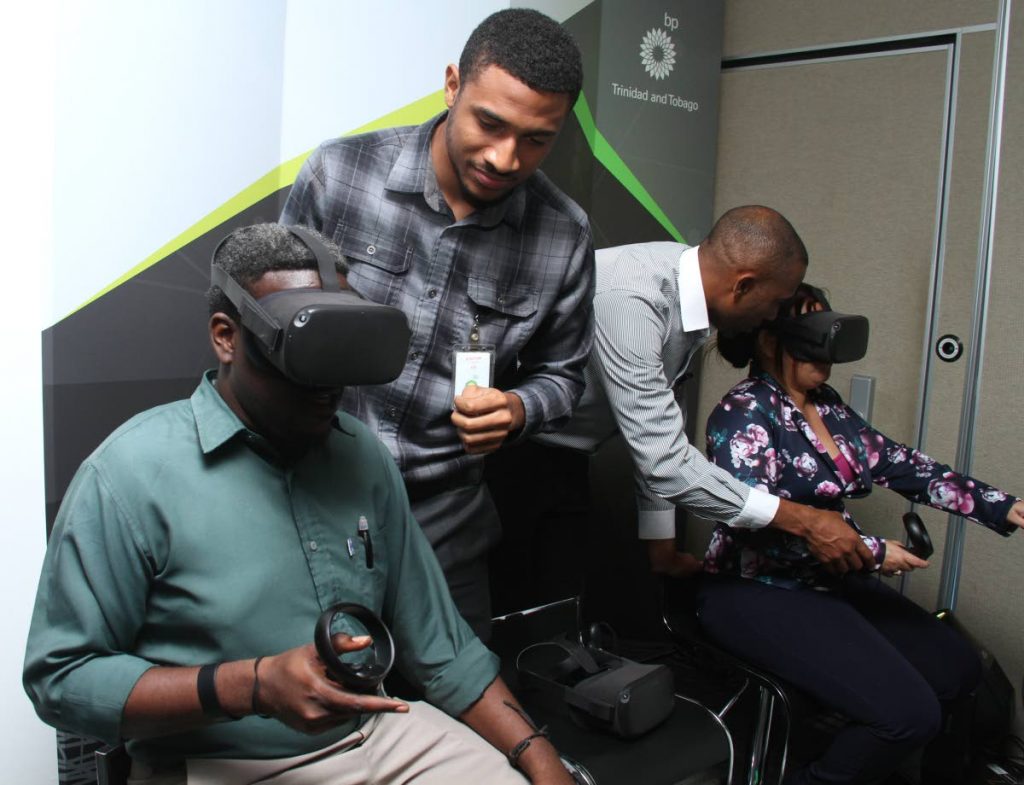 LOOKING INTO THE FUTURE: Journalists explore the vurtual reality gear during BPTT's technology open house at Albion Plaza, Albion Street in Port of Spain on Monday.  PHOTO BY AYANNA KINSALE - Ayanna Kinsale