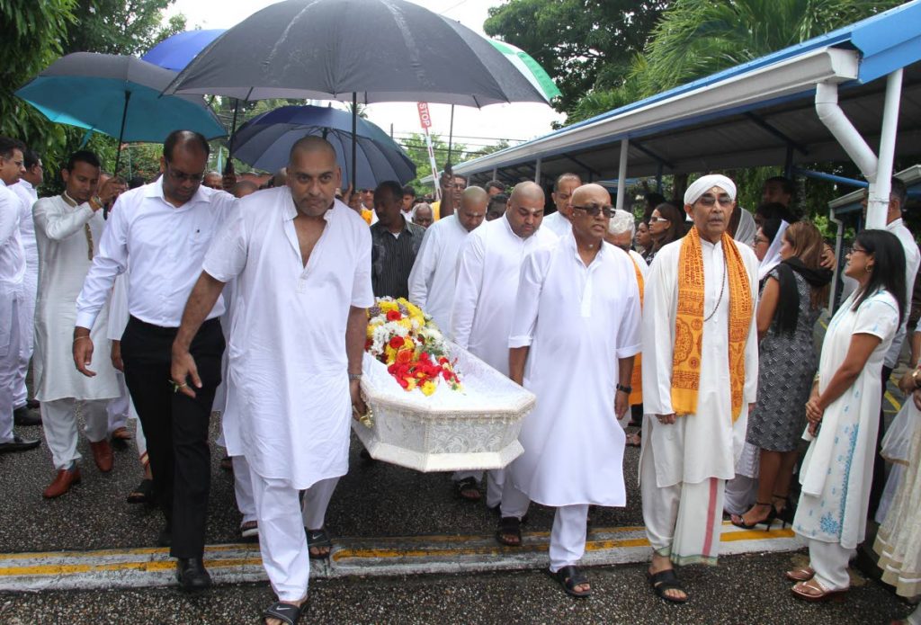 Pallbearers led by Vijay Maharaj, son of the late Satnarayan “Sat” Maharaj, carry his body during his funeral at the Sanatan Dharma Maha Sabha (SDMS), Lakshmi Girls’ Hindu College, St Augustine, yesterday.
 - Ayanna Kinsale