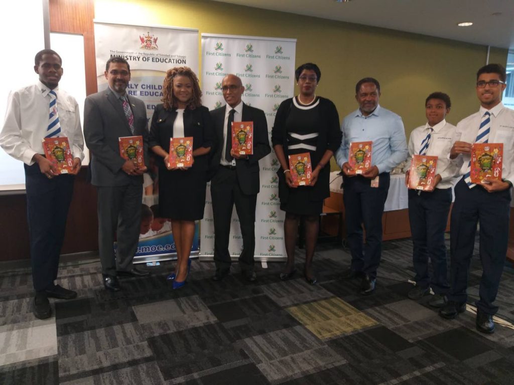 Author Nasser Khan, fourth from left, poses with students from his alma mater St Mary's College and other officials at Tuesday's launch of his book Celebrating Trinidad and Tobago's Culture and the Arts at the Ministry of Education on St Vincent Street, Port of Spain.  - Tyrell Gittens