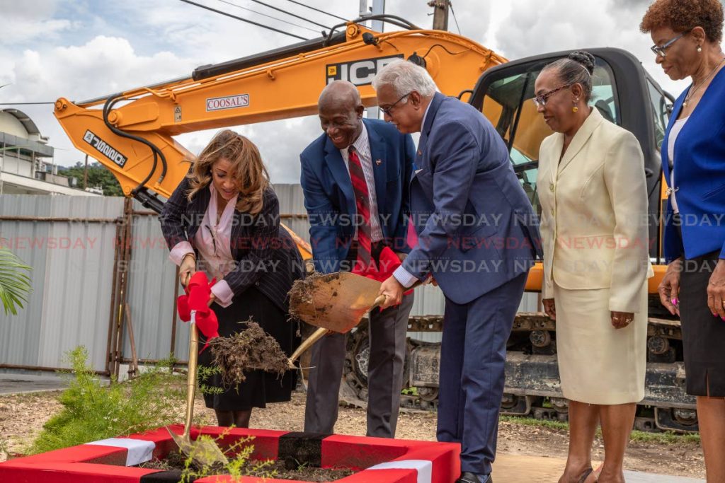 From left: North West Regional Health Authority Chairman Lisa Agard, Prime Minister Dr Keith Rowley and Minister of Health Terrence Deyalsingh turn the sod to start construction of the new central block at the Port of Spain General Hospital as Jackie Ganteaume-Farrell and Maureen Braveboy look on Tuesday - JEFF K MAYERS