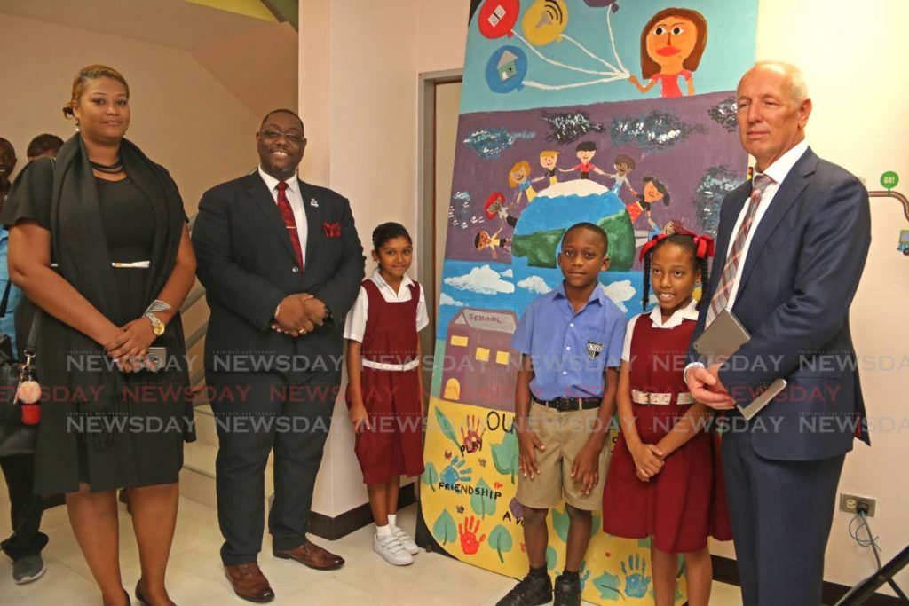 Children's Authority, Hanif E.A Benjamin and Ambassador, EU Delegation to T&T, H.E. Aad Biesebroek with students and teacher of Arima New Government School at the primary schools unveiling mural art project at Children's Authority, St. Thomas Village, Chagaunas. - Marvin Hamilton