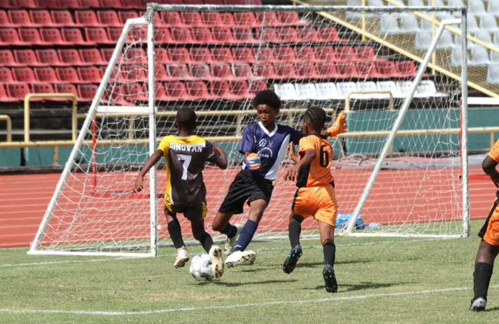 File Photo: Donovan Drayton(L) of Beach Camp Community School tries to score a goal against Enterprise Government Primary School during the National Primary Schools Football League Under-12 final, at the Hasely Crawford Stadium.  - Ayanna Kinsale