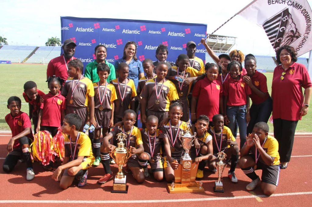 CHAMPS: Beach Camp Community School display their trophies after winning the Atlantic National Primary Schools Football League Under12 title, at the Hasely Crawford Stadium,yesterday. - Ayanna Kinsale