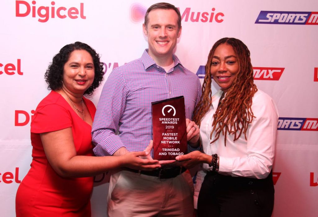 Digicel's head of marketing Trijata Maraj, consumer director Abraham Smith and CEO of the Digicel Foundation Penny Gomez at the launch of the company's Christmas campaign at the Queen's Park Oval on Thursday.  PHOTO BY AYANNA KINSALE - Ayanna Kinsale