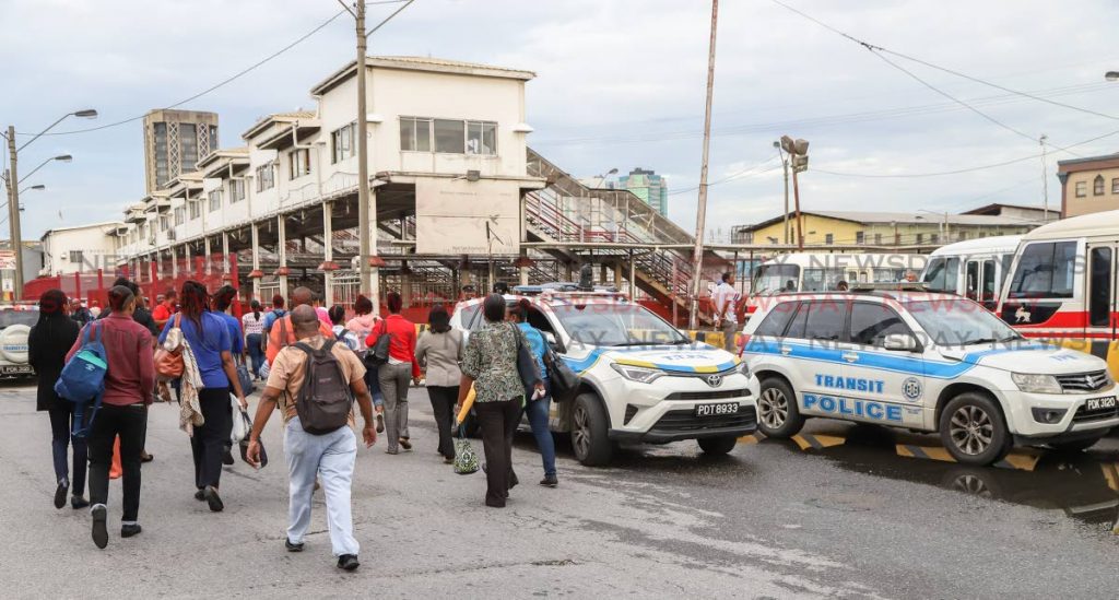Commuters were forced to walk into City Gate from as far as the Central Market in Port of Spain on Friday morning as several maxi-taxi drivers refused to enter the transport hub in protest. - JEFF K MAYERS