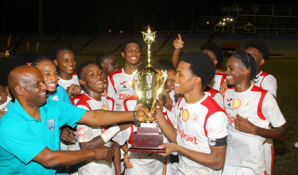 St Anthony's captain Jordan Barclay (second from right) collects the North Zone Intercol trophy after Friday's 2-1 win over East Mucurapo. PHOTO BY ROGER JACOB. - ROGER JACOB