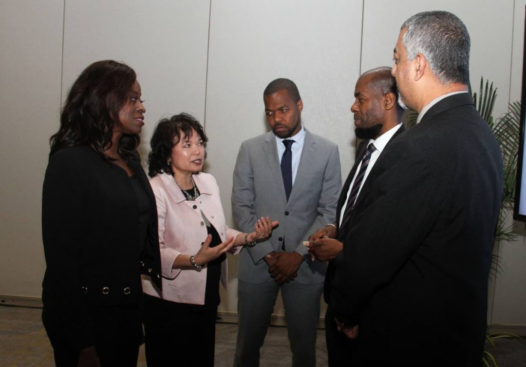 Minister of Communications Donna Cox, left, has a conversation with senior director of Cable and Wireless Business Elizabeth Ammon, Cable and Wireless Communications Country Manager Kurleigh Prescod, Ministry of National Security permanent secretary Vel Lewis and Ministry of Health permanent secretary Asif Ali at the launch of C&W's One Government, Hyatt Regency, Port of Spain on Friday. PHOTO BY AYANNA KINSALE - AYANNA KINSALE
