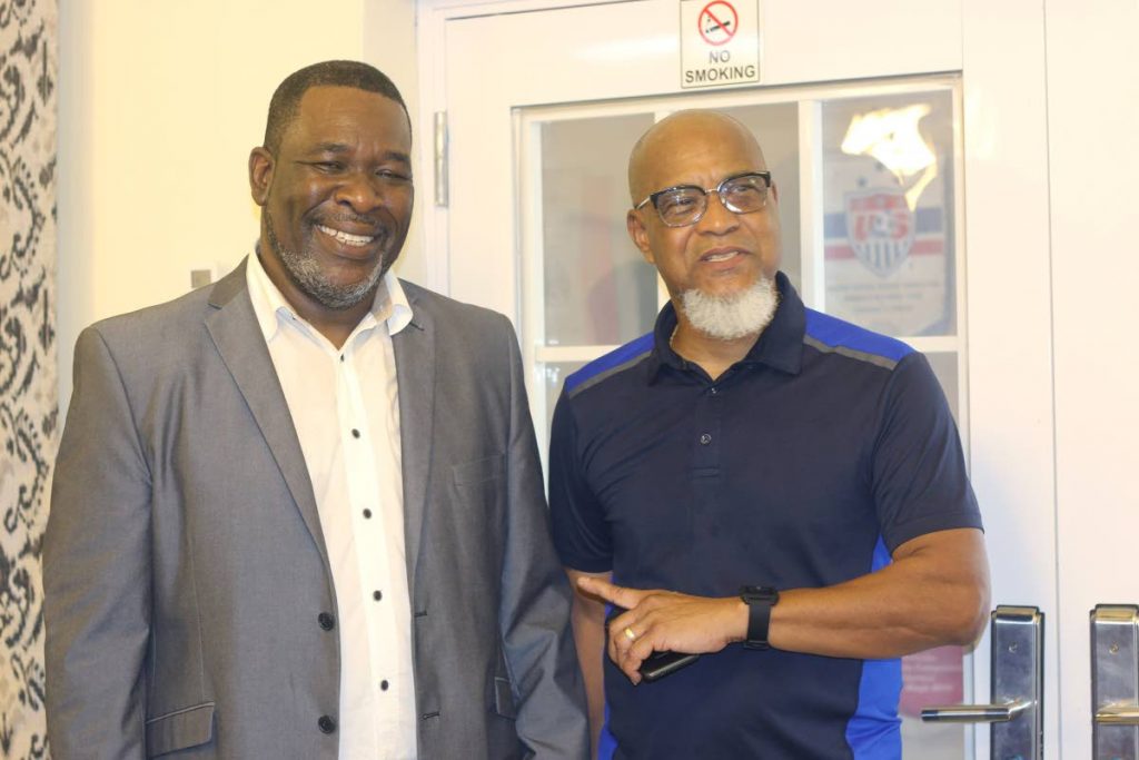 TT Football Association (TTFA) director Keith Look Loy (R) congratulates newly-elected president of the TTFA William Wallace (L) after the latter dethroned David John-Williams, at the Home of Football, Balmain,Couve, on Sunday. - Marvin Hamilton