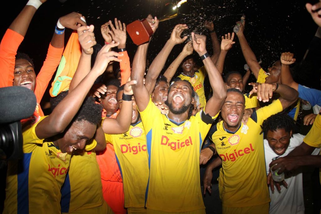 Presentation College San Fernando players celebrate after beating Naparima College, in the Coca Cola Intercol South Zonal final, at the Manny Ramjohn Stadium, on Monday.  - Lincoln Holder