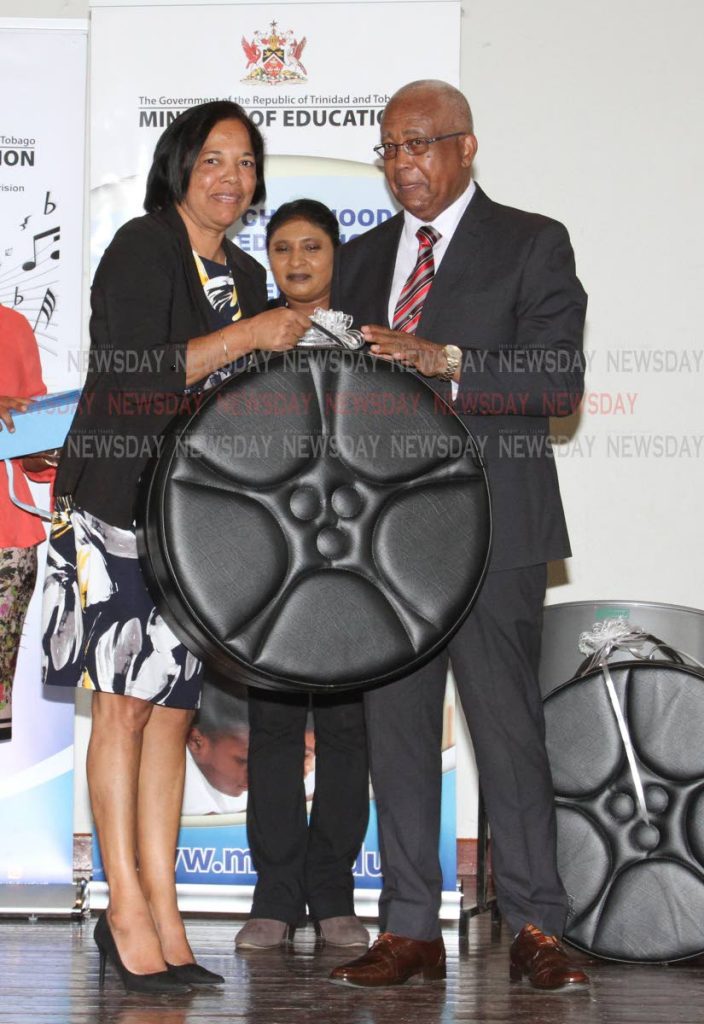 Minister of Education Anthony Garcia, gives Northeastern Sangre Grande Government  ECCE administrator Zobida Ali-Mannan a steelpan as part of the Music Education Expansion Initiative project. The event was held at the Arima New Government Primary School, Tumpuna Road South, Arima, Wednesday. - ANGELO_MARCELLE