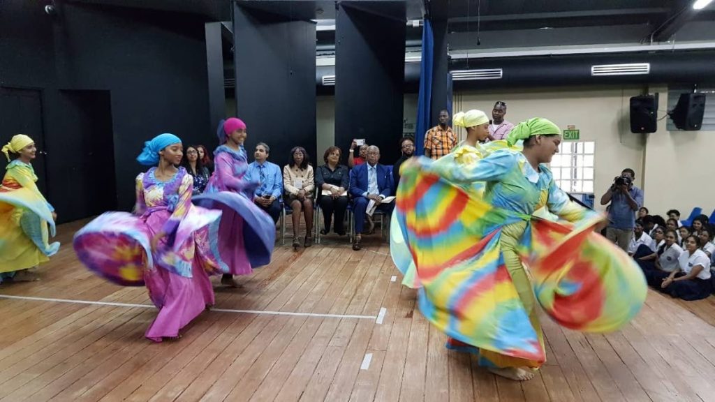 Students of Naparima Girls’ College, San Fernando perform a cultural dance during a visit to the school by Minister of Education Anthony Garcia on Tuesday. - YVONNE WEBB