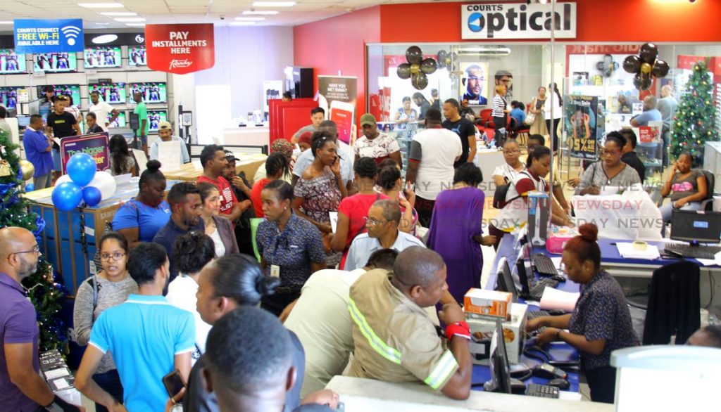 Customers wait in long lines to purchase discounted items during a Black Friday sale event at Courts Megastore, Churchill Rooservelt Highway, El Socorro, on Friday. - ROGER JACOB