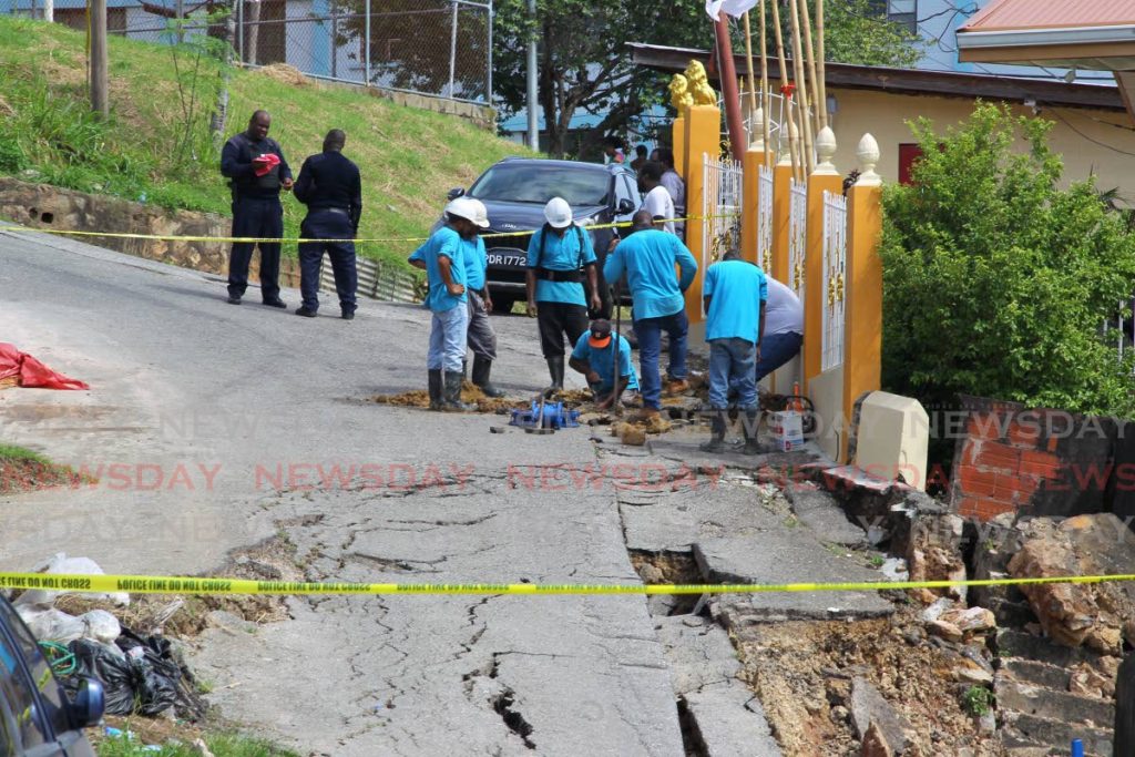 In this November 20 file photo, a WASA crew repairs a wain main damaged by a landslip on Wharton Road Ext, Trou Macaque, Laventille. - ROGER JACOB