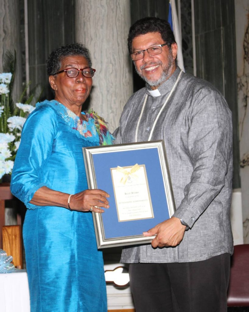 Hazel Brown receives her St Joseph's Port of Spain, Hall of Excellence award from Archbishop Charles Jason Gordon in 2019. - ANGELO MARCELLE