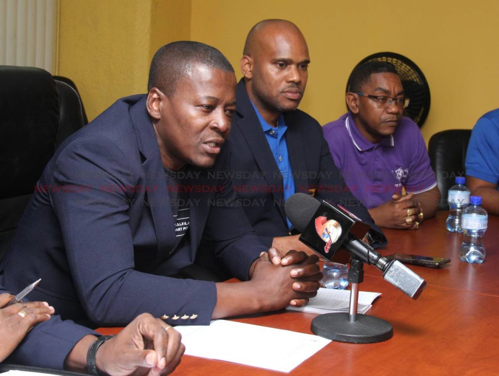ACT NOW: President of the Police Social and Welfare Association, Gideon Dickson, speaks at a press conference at the association's Riverside Plaza, Port of Spain office on Sunday. With him are treasurer Jason Johnson and central communication representative Nigel Guerra. PHOTO BY AYANNA KINSALE  - Ayanna Kinsale