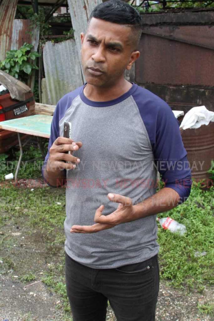 UNC local government candidate for Sangre Grande South Calvin Seecharan complains about PNM supporters campaigning on election morning in Sangre Grande on Monday. - ANGELO MARCELLE