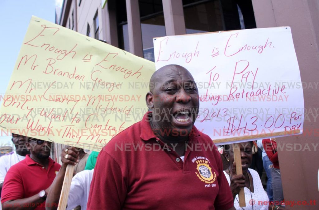  NUGFW members protest outside HDC headquarters on South Quay, Port of Spain on Wednesday. - ANGELO MARCELLE