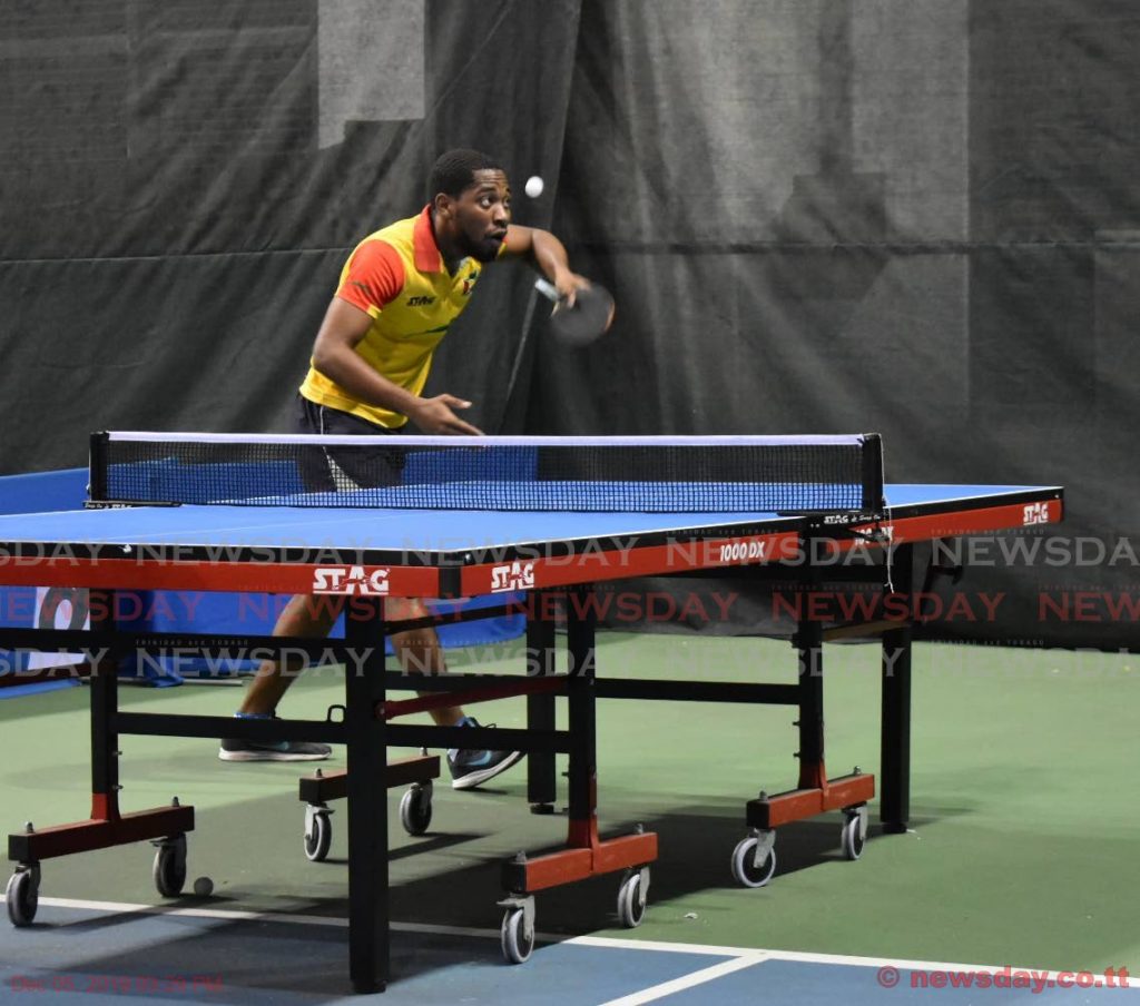 QPCC's Shemar Britton (L) serves against Aaron Wilson (not in picture) during a Super Singles Table Tennis Tournament match, held at the National Racquet Centre, Tacarigua, on Wednesday.  - Sherdon Pierre