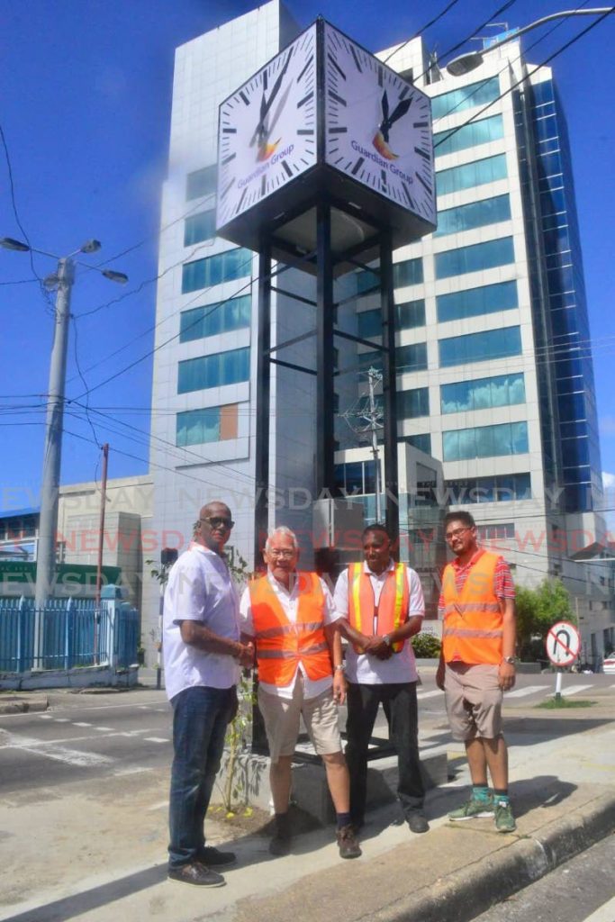San Fernando Mayor Junia Regrello, left, congratulated by former Senate President Michael J. Williams, 2nd from left, at the commissioning of an 18-foot high clock at the western end of Harris Promenade in San Fernando over the weekend. PHOTO COURTESY MAYOR’S OFFICE - 