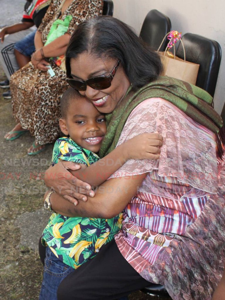 HUG FROM AUNTY MARLENE: PoS South MP Marlene Augustine hugs Kaydon Williams, four, yesterday at her annual Christmas hamper distribution at her constituency office in Port of Spain. PHOTO BY ANGELO MARCELLE - ANGELO_MARCELLE