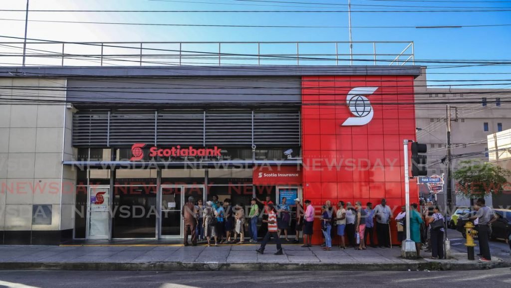 Customers in line  outside Scotia Bank Ltd, Park Street, waiting to exchange their old $100 notes. - JEFF K MAYERS