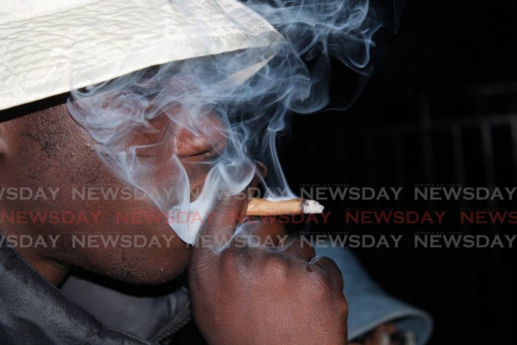 A man smokes a marijuana joint.  - 