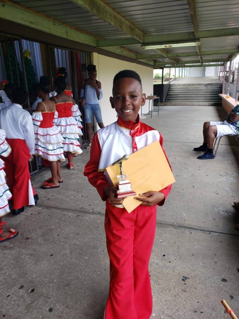 Josiah Abraham, 11, with his best lead singer trophy at the Sancouche Fourth Annual Pre and Primary Schools’ Parang Competition on November 9. - 