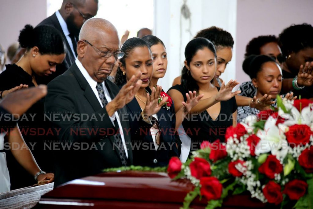 Friends and close family members say final prays at  the funeral service of Raymond Tim Kee at the St. Theresa's RC Church in Woodbrook.  - SUREASH CHOLAI