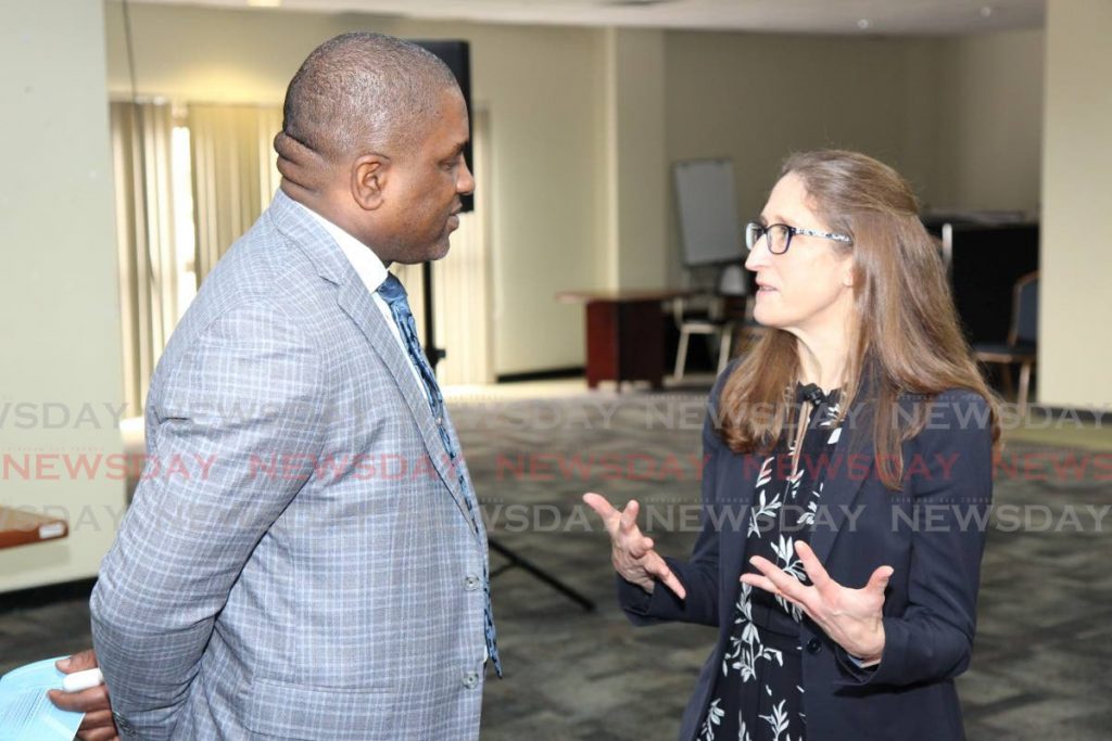 Secretary of Finance and the Economy Joel Jack, left, chats at a seminar hosted in collaboration with Central Bank to discuss the new $100 bill at the Penthouse, Victor E Bruce Financial Complex, Scarborough on Thursday.  - THA