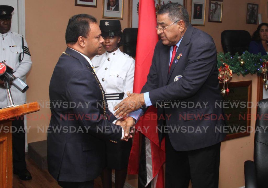 Newly appointed Chairman of Sangre Grande Regional Corporation Anil Juteram is congratulated by former Chairman Terry Rondon at the swearing in ceremony held at the Sangre Grande Regional Corporation on Tuesday.  - Ayanna Kinsale