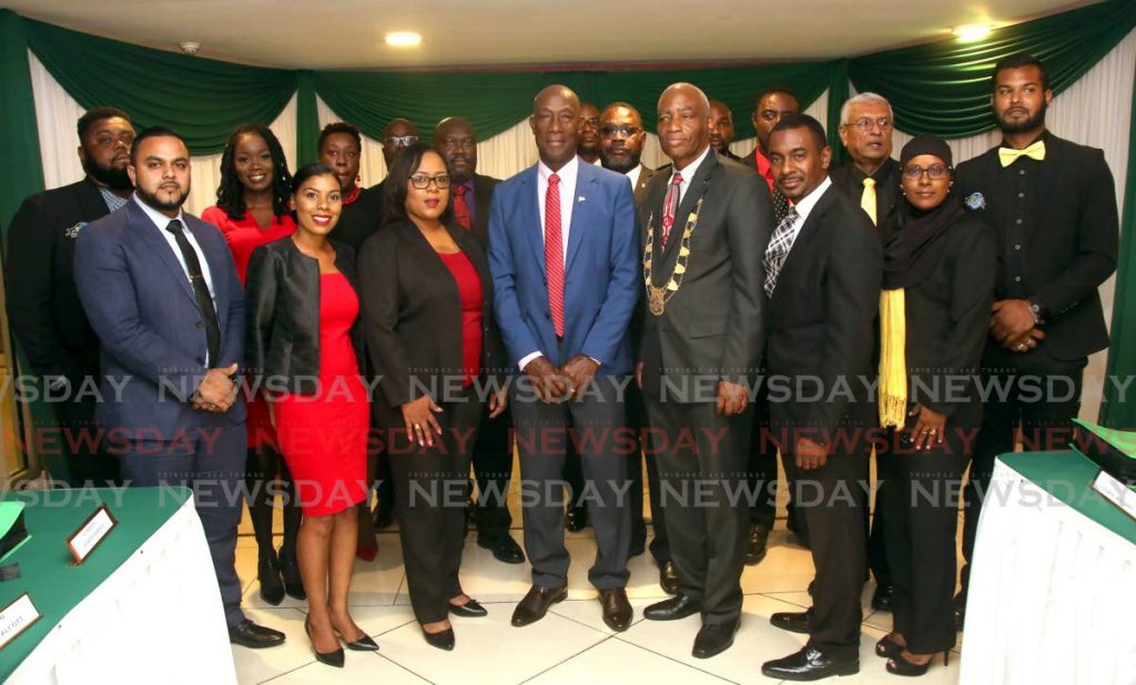 READY TO WORK: Prime Minister Dr Keith Rowley is surrounded by councillors and aldermen of the new council of the San Juan Laventille Regional Corporation at Angostura House in Laventille on Tuesday. 
 - Sureash Cholai