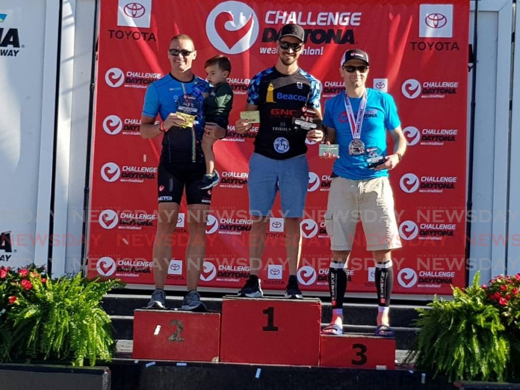 TT triathlete Jason Costelloe, centre, after winning his age group at the Challenge Daytona 70.3 Triathlon event in Florida, on Sunday. - 